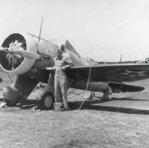 Lt.  Lamar Gillett standing next to P-26 Plane.  At age 20 he joined the Ar